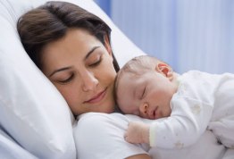 photolibrary_rf_photo_of_mom_napping_with_newborn